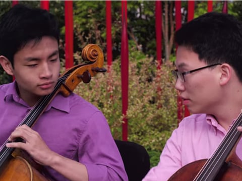Teen cellists Jeremy Tai and Minku Lee playing at Chihuly Garden and Glass.